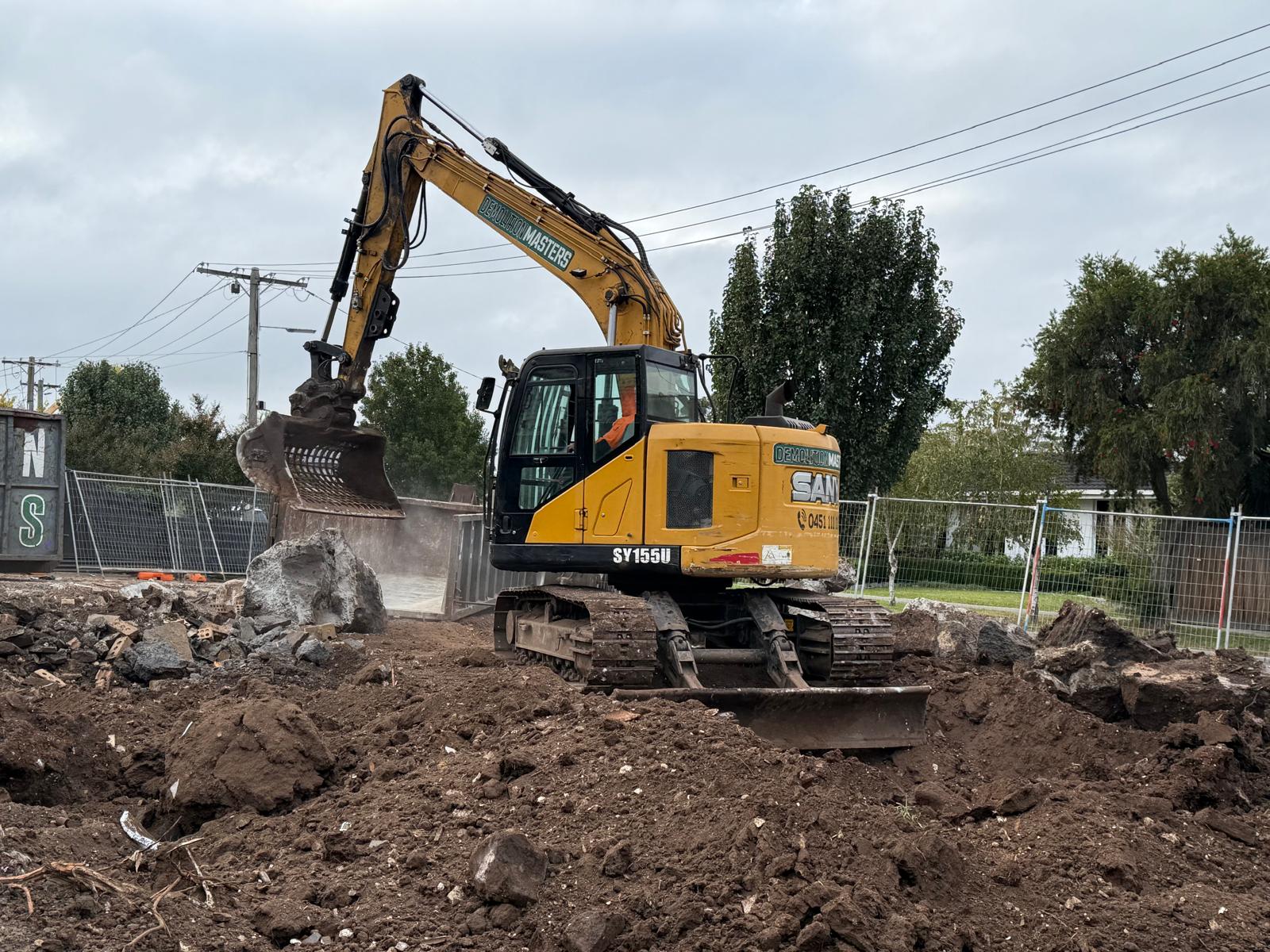 Yellow Demolition Masters excavator on a Melbourne earthworks site
